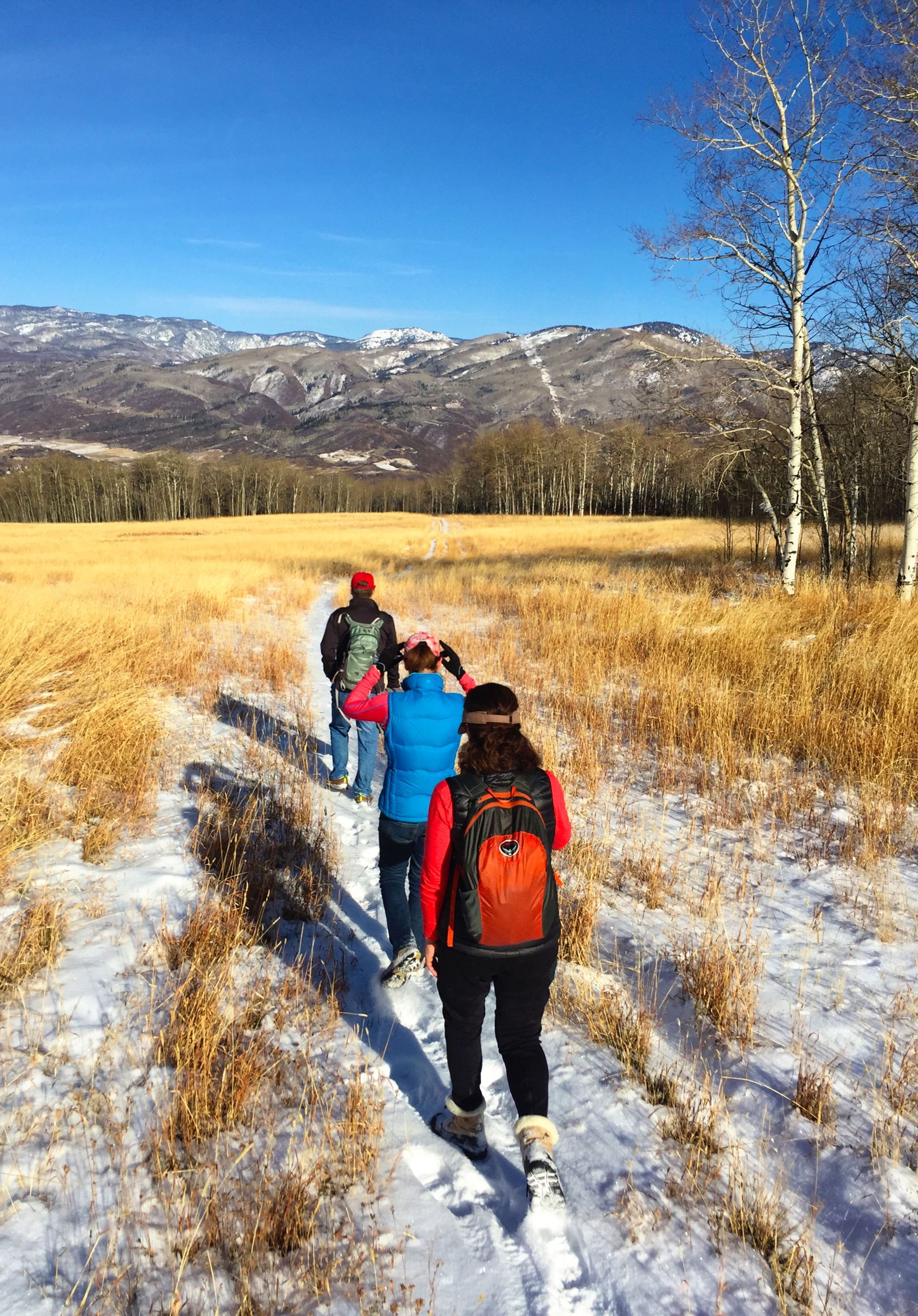 Hikers going down Emerald mountain after an early snowfall 