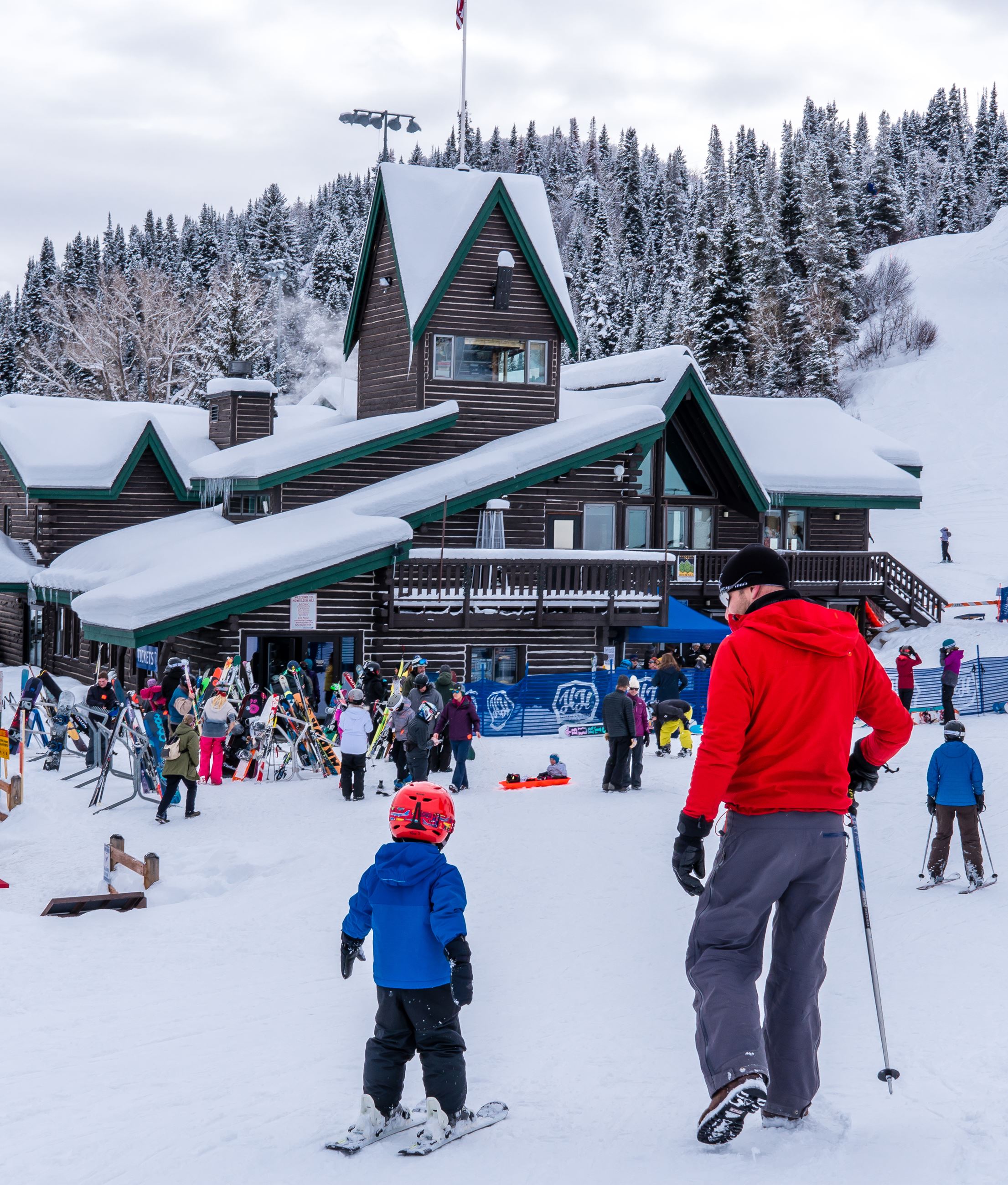Skiers in front of the historic Howelsen Hill Lodge at Howelsen Hill Ski Area. 