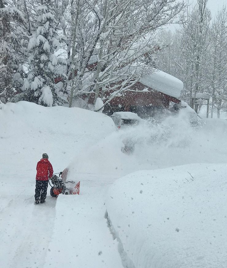 Person snow blowing their driveway
