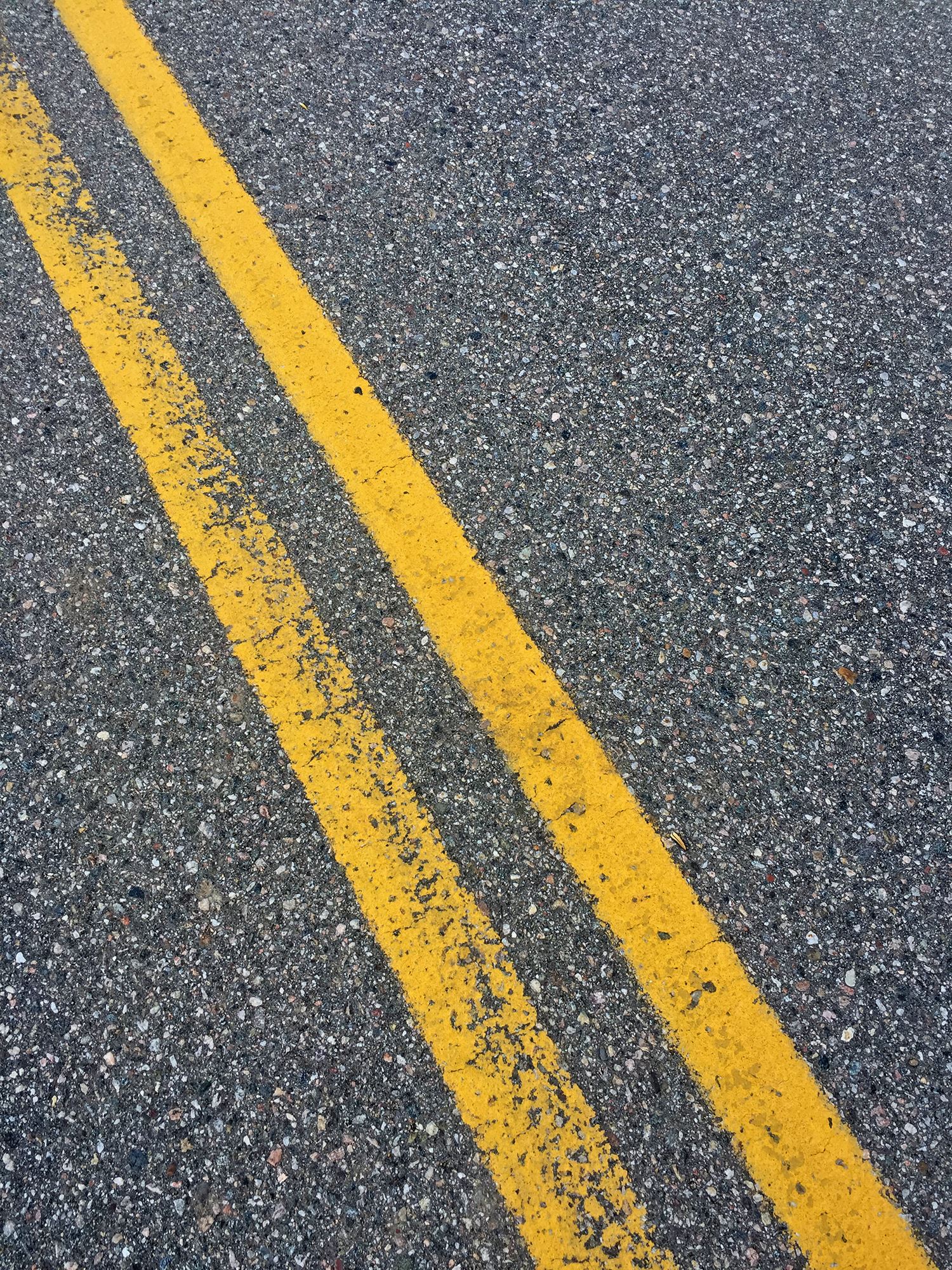 close up of yellow lines on a street